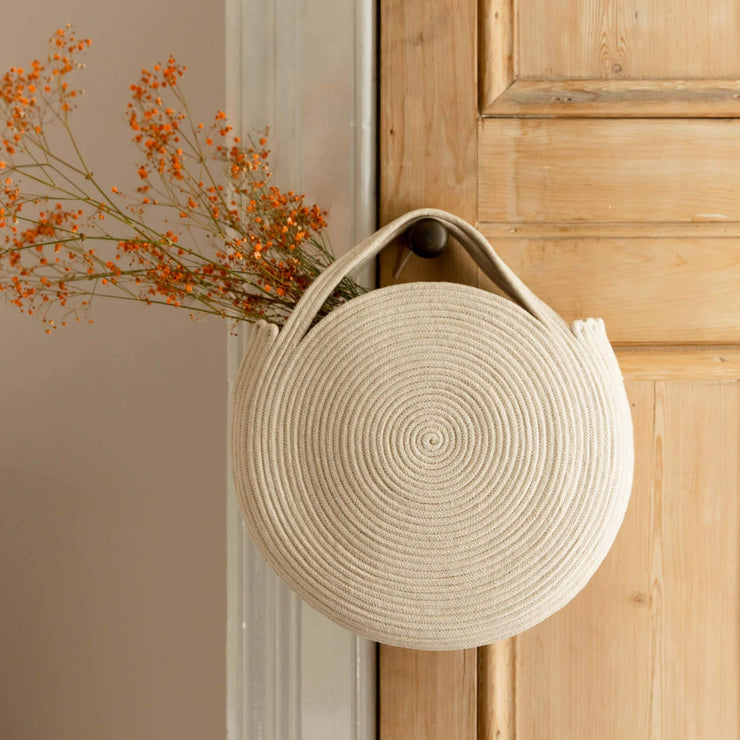 Finished cotton rope basket bag diy project in cotton rope hanging from a door handle with dried flowers in, by La Basketry