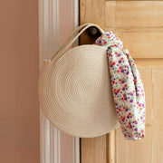 Finished cotton rope basket bag diy project in cotton rope hanging from a door handle with a scarf tied to it, by La Basketry