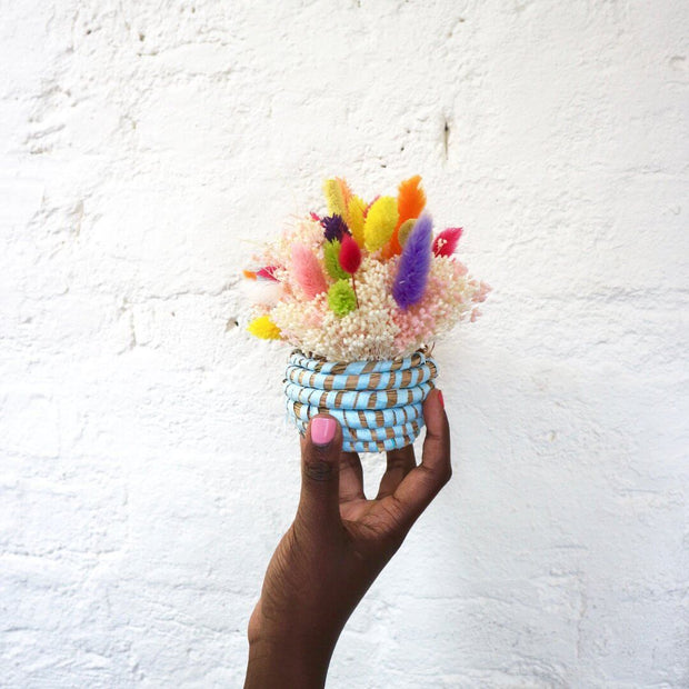 a miniature woven basket made from the mini basket kit from la basketry, shown in turquoise