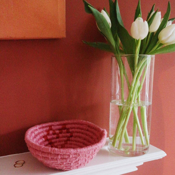 la basketry galentines day limited edition twine basket kit in pink and red with love heart motif shown on a shelf with white tulips and an orange wall